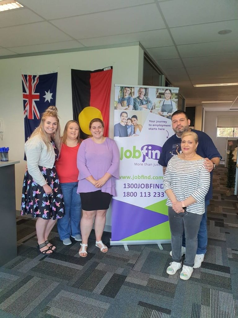 Accessibility Day - image of five smiling people standing in front of a Jobfind pullup banner