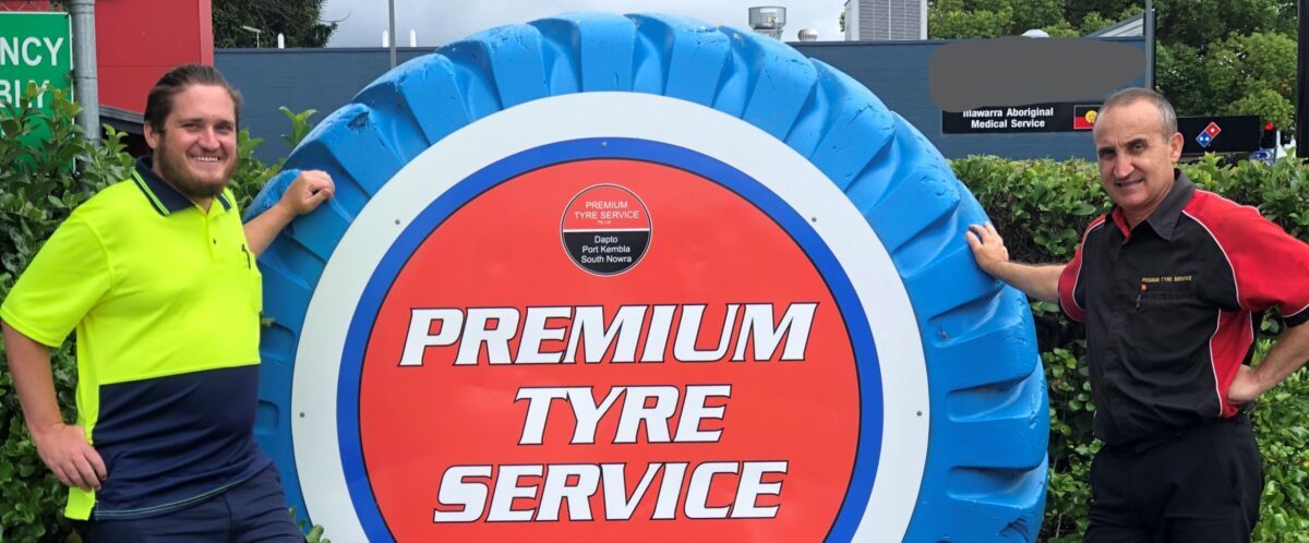 A job for everyone - image of two men in uniform standing next to a large blue tyre