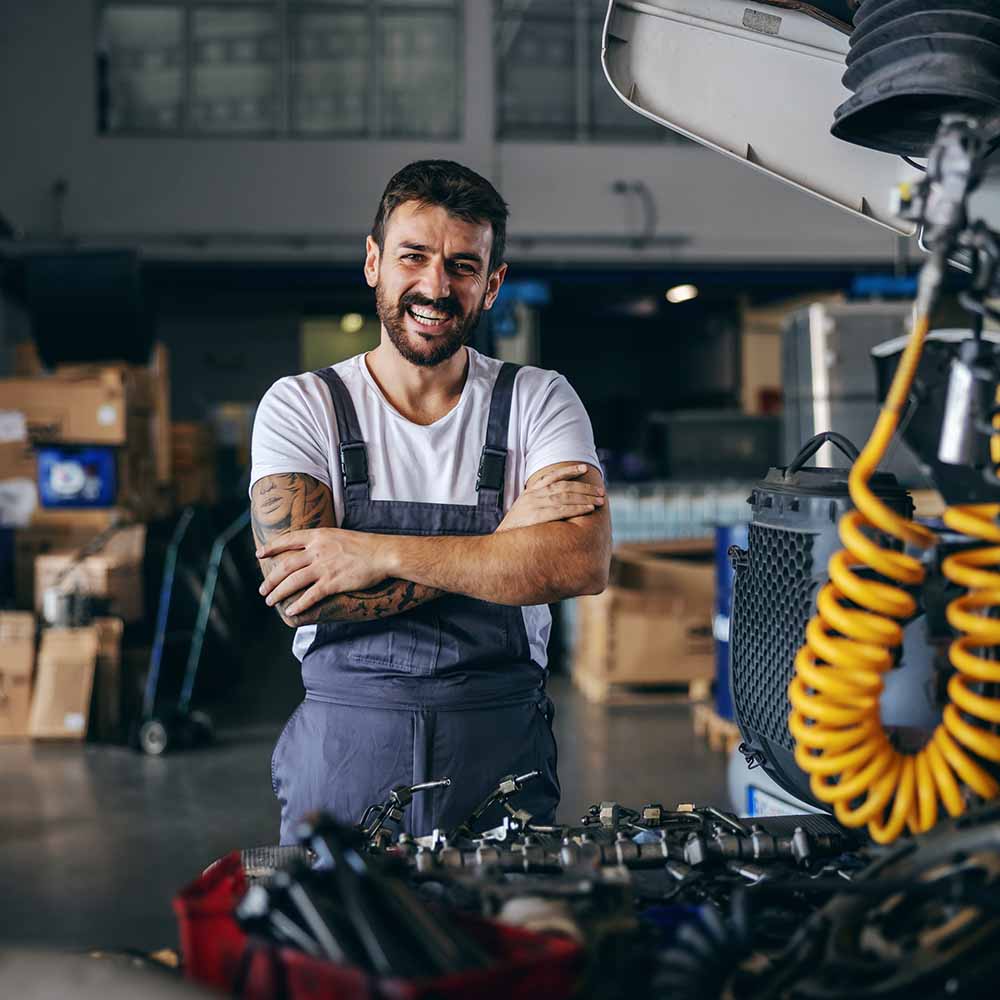 How we can help - image of smiling mechanic in workshop