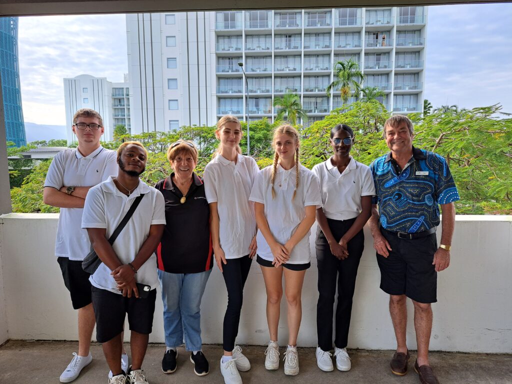 Photograph of hospitality TTW students standing on a balcony smiling and facing the camera.